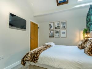 a bedroom with a bed and a flat screen tv at Station View in Pickering
