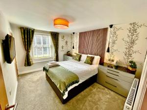 a bedroom with a bed and a television in it at Station View in Pickering