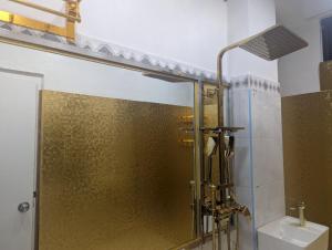 a shower with a glass door in a bathroom at Ontrack Travel Transit Hotel in Male City