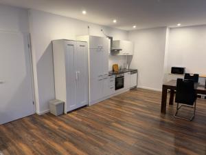 a kitchen with white cabinets and a table in a room at Centrally located in Coesfeld in Coesfeld +13 photos