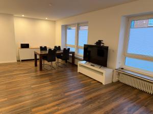 a room with a dining table and a tv in it at Centrally located in Coesfeld in Coesfeld