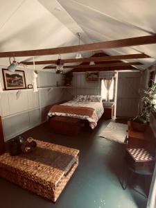 a bedroom with two beds and a table in a room at Wech Cottage in Warkworth