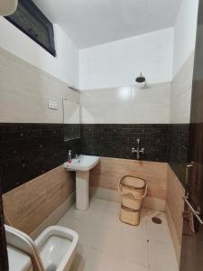 a bathroom with a sink and a toilet and a sink at Hotel Gulmohar in Haridwār +46 photos