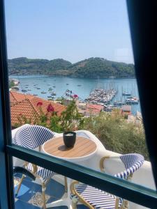 a balcony with a table and chairs and a view of a harbor at Oikies Skiathos in Skiathos