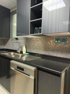 a kitchen with a sink and a counter top at Eid Holiday in Muscat