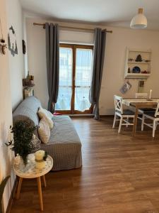 a living room with a bed and a table at Attico - Terrazza su Castello in Castel di Sangro