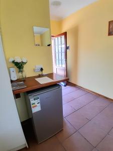 a kitchen with a counter and a refrigerator in a room at Meerkat Manor on Main in Clarens