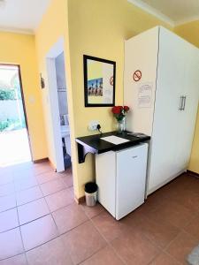 a room with a counter and a refrigerator at Meerkat Manor on Main in Clarens +10 photos