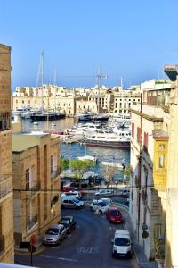 a view of a marina with cars parked on a street at Grand Arcanum Apartment 2 - Comfortable and Elegant in Senglea