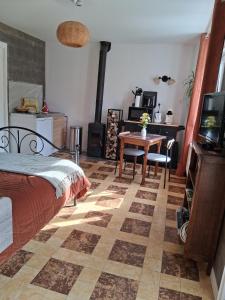 a bedroom with a bed and a table with a television at Chez Claire et Olivier in Nabringhen +95 photos