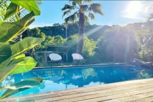 a house with a swimming pool with two chairs next to it at プールサイドヴィラ館山 in Tateyama +8 photos