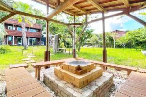 a patio with a fire pit under a pavilion at プールサイドヴィラ館山 in Tateyama