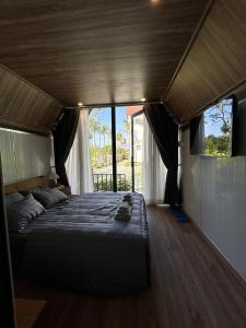 a large bed in a room with windows at Homestay Mộc An in Lagi +70 photos
