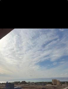 a view of a cloudy sky from a building at Seaview horizon apartment in Sowayma