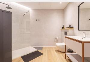 a bathroom with a toilet and a sink and a shower at Mestalla flats & Rut in Valencia +34 photos