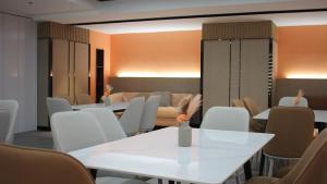 a room with white tables and chairs and a couch at Golden Seagulls Hotel in Manila +81 photos