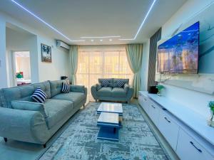 a living room with a couch and a table at Nitro Homes Nyali-Coral Sands in Mombasa