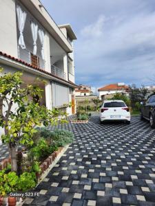 a white car parked in front of a house at Albert's house for rent in Vlorë