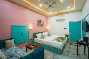 a hotel room with a bed and a couch at Shri Prem Villa in Jaisalmer