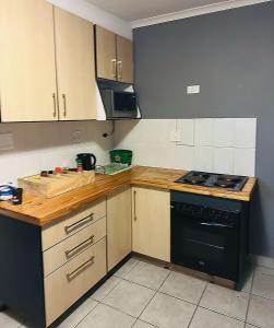 a kitchen with wooden counters and a stove top oven at AAA Luxury Cottages in Cape Town
