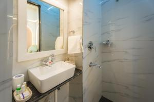 a bathroom with a sink and a shower with a mirror at Shri Prem Villa in Jaisalmer +30 photos