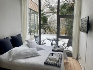 a bedroom with a bed and a view of a patio at Room Art Lovers in Marmagen
