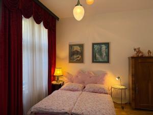 a bedroom with a large bed and a window at Villa Pazelt Top1 in Bad Vöslau