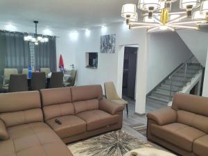 a living room with a couch and a staircase at Jannat Residence in Curepipe