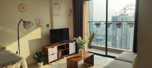 a living room with a television and a large window at SHome, căn hộ 55m2,2 phòng ngủ, Oceanpark 1 in Gia Lâm Pho