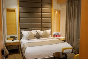 a bedroom with a large bed with a large headboard at Varju Villa in Udaipur +88 photos