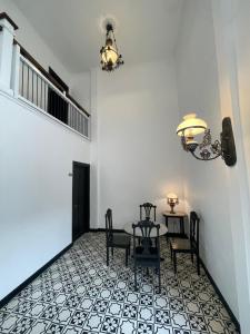 a dining room with a table and chairs on a tile floor at Homestay Harmonie Cepu in Padangan