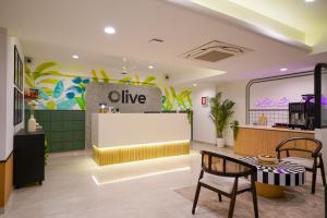 a cafe with a table and chairs in a room at Olive Hotel Wakad by Embassy Group in Pune