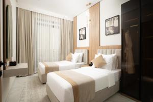 a hotel room with two beds and a window at Liora Boutique in Riyadh +55 photos