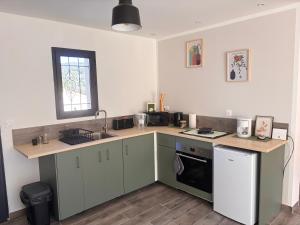 a kitchen with a sink and a counter top at Gîte du Courbier in Saint-Montan