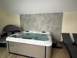 a jacuzzi tub in the corner of a room at Ferienwohnung Weitblick mit Whirlpool in Lasel +21 photos