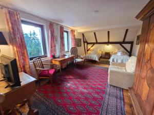 a hotel room with a bed and a living room at Dworek Adamski in Wałbrzych