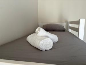 a white towel sitting on top of a bed at Elena's House in Methana