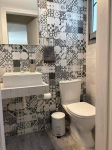 a bathroom with a toilet and a sink at Elena's House in Methana
