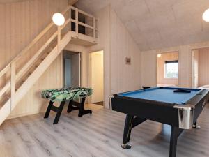 a pool table in a room with a staircase at 22 person holiday home in Jerup in Jerup