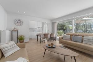 a living room with a couch and a table at Parkhouse C0 in De Haan
