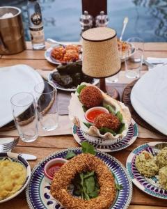 a wooden table with plates of food on it at Buena Vista Hotel&Restaurant in Marmaris +30 photos