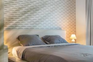 a bedroom with a large bed with a white headboard at Parkhouse C0 in De Haan