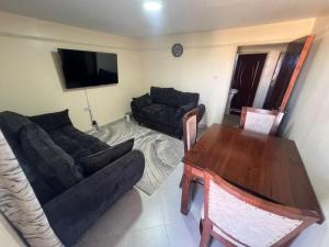a living room with a couch and a table at Gracious homes in Narok +3 photos