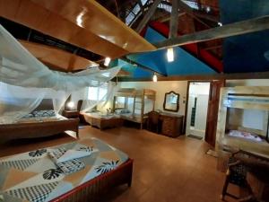 a room with two beds and a room with a ceiling at Bermuda Beach Resort in Lagob