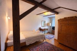 a bedroom with a bed and a dresser and a desk at Dworek Adamski in Wałbrzych