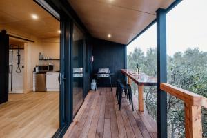a kitchen and dining area of a tiny house at Casa Olea in Waipara +14 photos