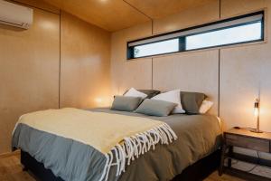 a bedroom with a bed in a room with a window at Casa Olea in Waipara