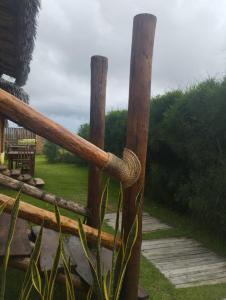 a wooden fence with a rope wrapped around it at Pedral Beach chalé e restaurante in Parnaíba
