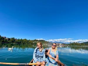 two women in a row boat on a lake at Boutique hotel ZBILJE in Zbilje