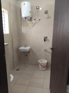 a bathroom with a toilet and a sink at Nayana comforts in Nandigunda